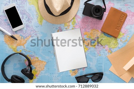 Traveller outfit on map background top view. Vacation planning, tourist stuff on atlas, copy space