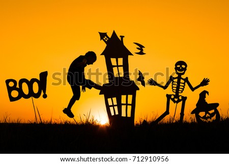 Happy little boy playing outdoors at the sunset time. Kid having fun. Concept of happy Halloween party.