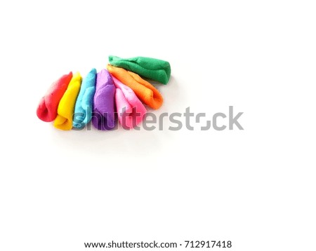 Multicolored plasticine (clay) cone shape placed on a white background