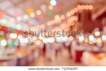 Abstract blur image of food stall at indoor day market with bokeh for background usage. (vintage tone)
