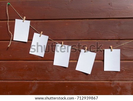 Five white sheets for notes on the wooden wall