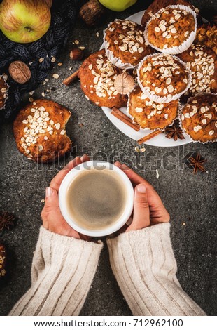 Autumn winter pastries. Vegan food. Healthy cookies, muffins with nuts, apples, oat flakes. Cozy atmosphere, warm blanket, girl drink coffee, hands in picture. Dark stone table. Copy space top view