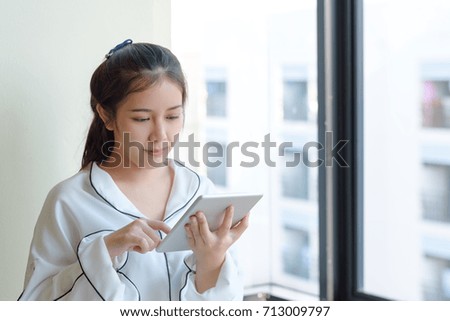 business technology concept ,asian women use tablet internet connect social network ,selective focus.