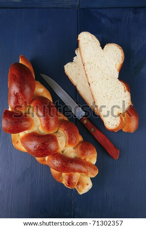 baked product : cut of challah over blue painted wooden board