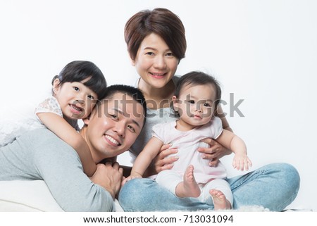 Young happy Asian family with kids.