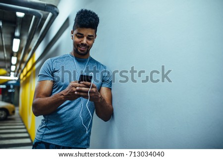 Photo of an african american athlete man listening to the music.