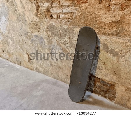 Old Skateboard on Cement with Old Brick Wall in Vintage Style 