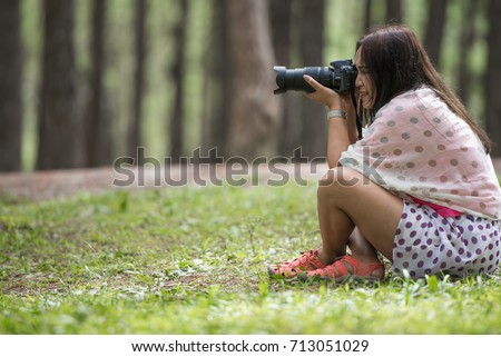 Woman with DSLR camera shooting pose, how to holding a camera concepts.