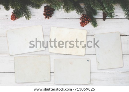 Blank photo frame album - empty old instant photos paper on wood table in christmas. top view, vintage and retro style