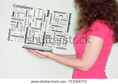 compliance concept. Photo for your design with text. attractive girl holding a black tablet computer in hands. in the profile. modern gadgets