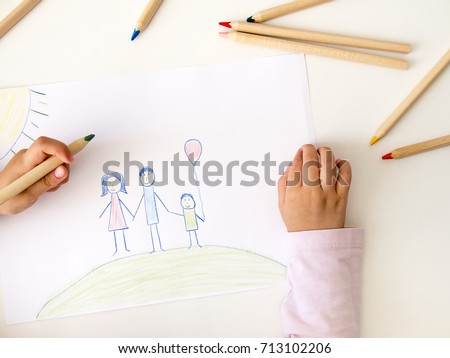 Child drawing her family on paper