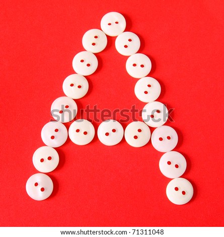 Letter "A" from buttons on a red background