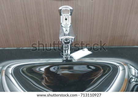 Water faucet in wash basin