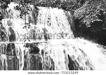 The small waterfall in Thailand. This image was blurred or selective focus. Black and white picture.