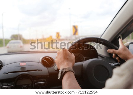 Man driver hands holding the car steering panel