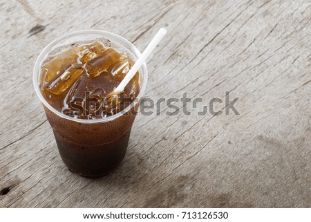 Close up ice of americano or black coffee on wood background