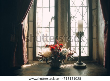 bouquet of flowers on the window of an old house. poppies and hydrangeas in a vase on a windowsill