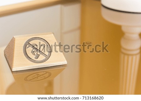 Nameplate with no smoking sign over the table