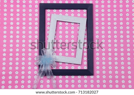 Double picture frame decorating by chiffon gift bow on cute pink flowers pattern