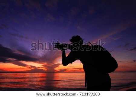 Photographer silhouette at beautiful sunrise.