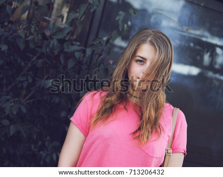 girl hipster on a black background with a hairstyle that covers half the face