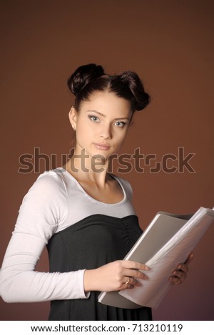 Young woman with folders of papers in hands