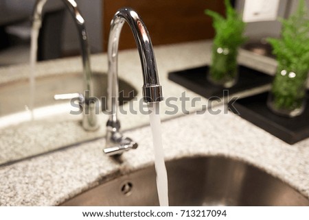 Close up of faucet , water flowing out of faucet,save water. Selective focus