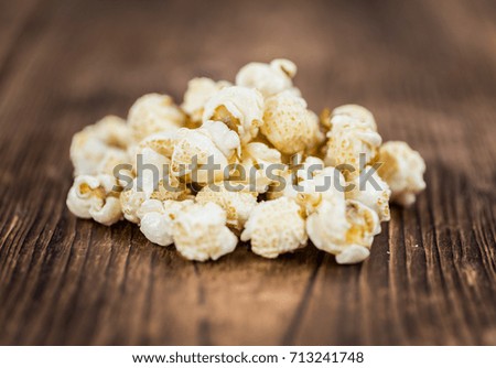 Fresh made Popcorn on a vintage background as detailed close-up shot