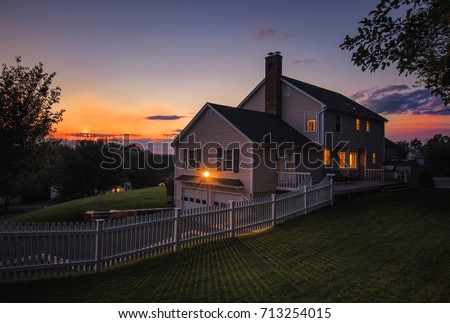 Beautiful colonial style house at sunset Royalty-Free Stock Photo #713254015