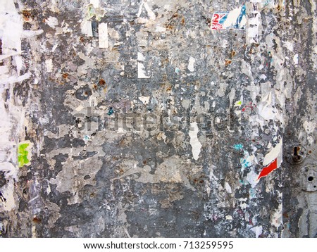 Grunge textured background with old torn notices on the metal fence. Style of  landscape. Rough iron Surface. Great background or texture.