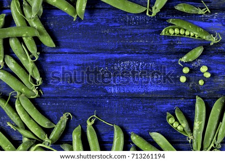 green peas on a blue wooden background. background in rustic style. bright green colors and blue. Vegetables
