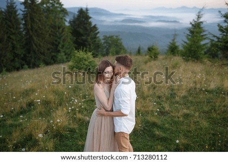 bride  and groom in the mountains with views of the beautiful green mountains