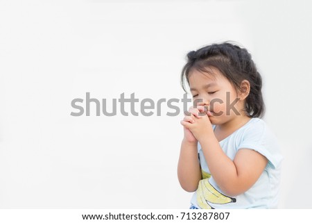 Little girl praying in the morning.Little asian girl hand praying,Hands folded in prayer concept for faith,spirituality and religion.white background.