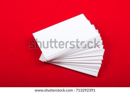 Blank business cards at red textured background. Template for ID. Top view