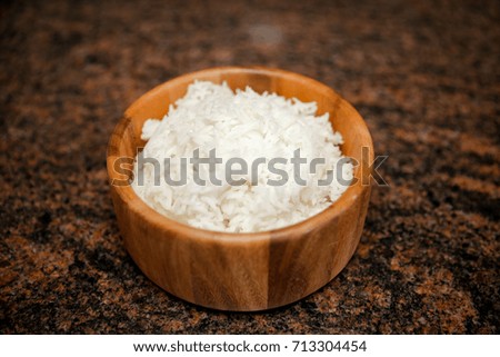 A wooden bowl of white rice