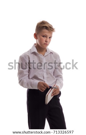 Blond boy in white shirt with notebook for notes in hands posing on white background