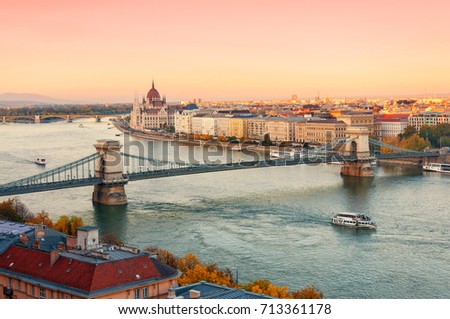 Picturesque dusk scenery of the Chain Bridge, the Parliament building and city historical downtown over the Danube river, Budapest, Hungary. Royalty-Free Stock Photo #713361178