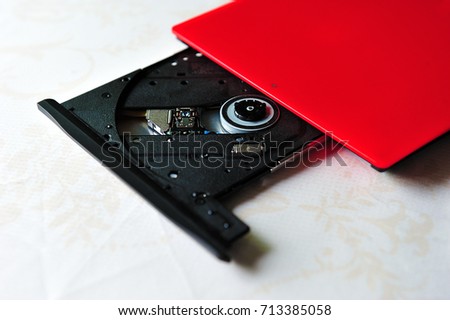 Portable slim external CD DVD burner writer isolated on white background, selective focus.  