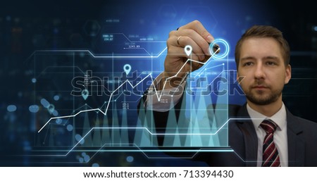 Young businessman making presentation in his virtual futuristic office touching digital panel with a pan. Modern business and finance concept.