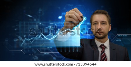 Young businessman making presentation in his virtual futuristic office touching digital panel with a pan. Modern business and finance concept.