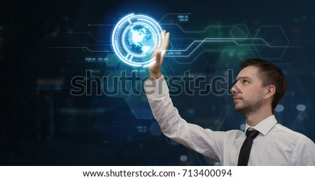 Young businessman working in his futuristic office using virtual screen. Modern business and technologies concept. Copy space for your text.