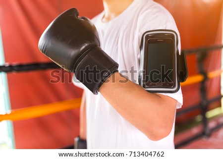 Athlete boxer use armband for smartphone. Technology concept.