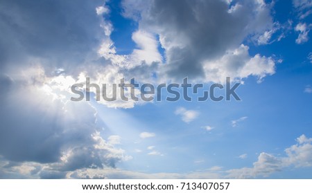 sun behind cloud and light ray.