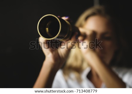 Caucasian woman using telescope spyglass Royalty-Free Stock Photo #713408779