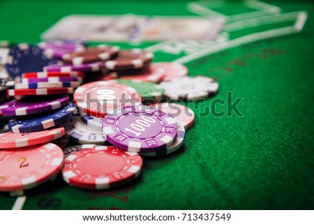 Chips are like money in a casino, placed on a green table as a symbol of the coin used to bet on a casino.Concept about entertainment and gambling