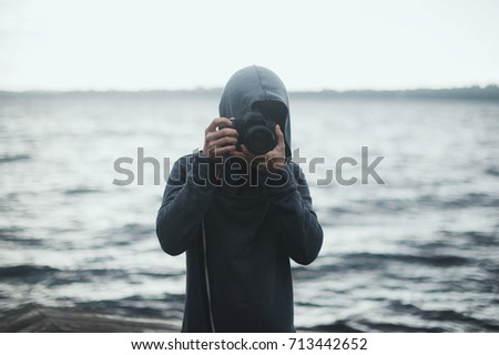 Man with Camera in Front of Ocean
