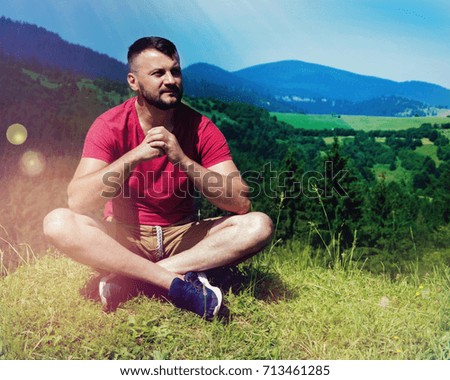 Young man in beautiful nature panorama with mountains.