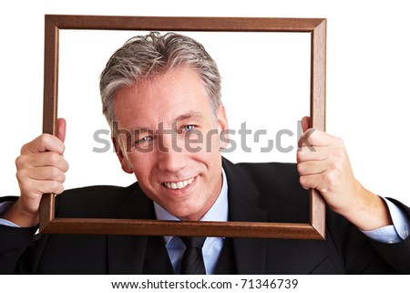 Smiling senior business man looking through an empty frame