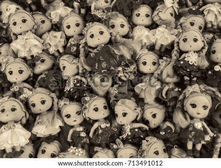 Many small dolls on the counter.