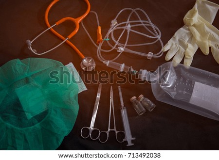 Surgeon and surgical tools closeup on dark background